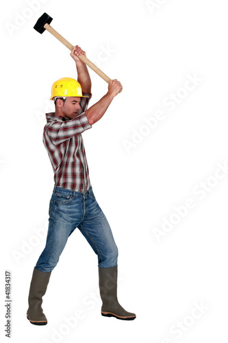 A manual worker with a sledgehammer.
