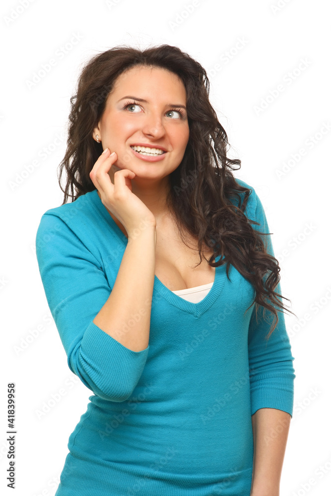 A smiling woman looking up, touching her face A smiling woman looking up, touching her face