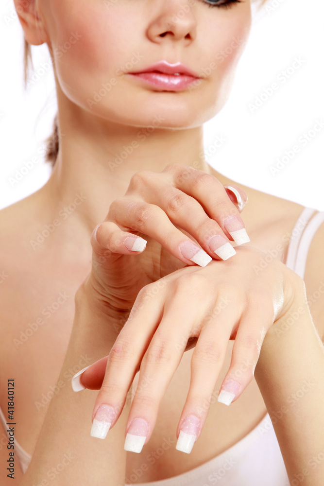 A beautiful woman applying a cream on hands A beautiful woman applying a cream on hands