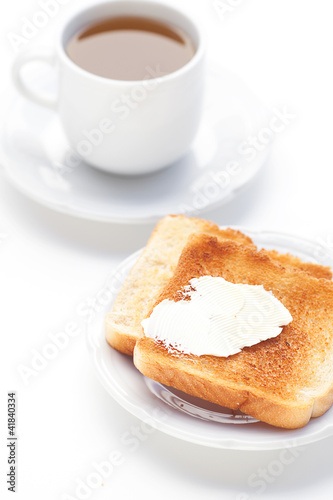 tea and toast with butter isolated on white