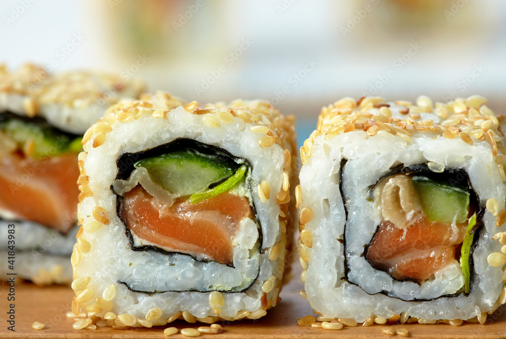 sushi with salmon and cucumber with sesame seeds sushi with salmon and cucumber with sesame seeds