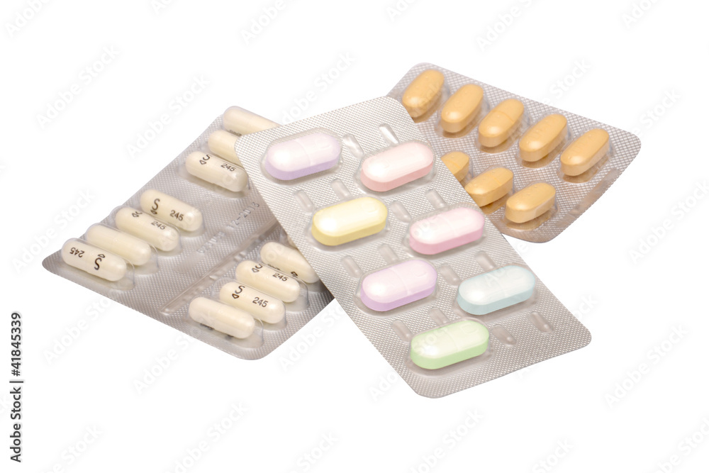 Multicolored medicine pills on the white background Multicolored medicine pills on the white background