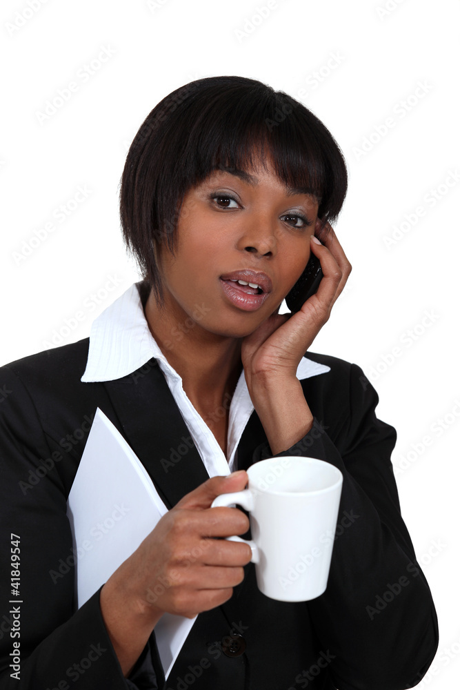 Businesswoman with mug of coffee and telephone Businesswoman with mug of coffee and telephone