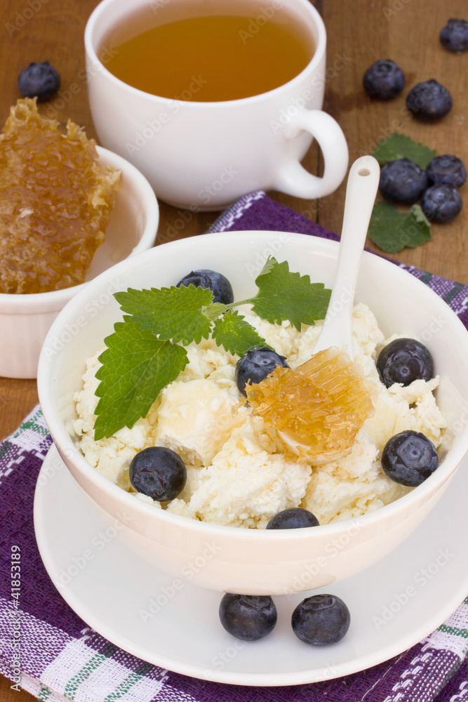 A healthy breakfast of cheese, berries and honey A healthy breakfast of cheese, berries and honey