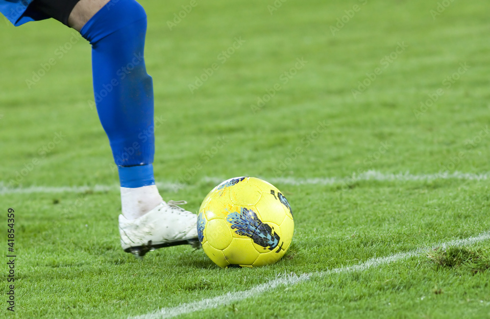 Soccer player running after the ball