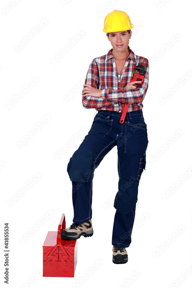 Female plumber standing on white background Female plumber standing on white background