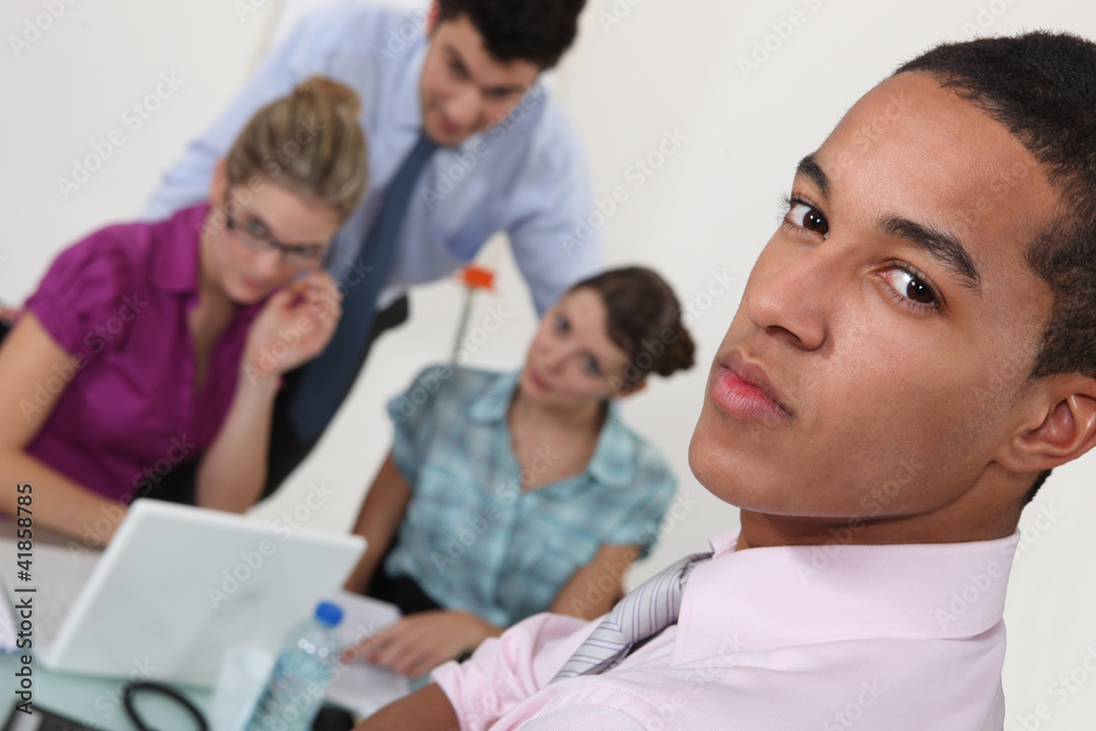 Serious young businessman with colleagues Serious young businessman with colleagues
