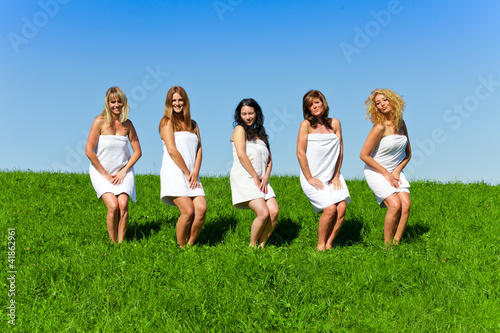 Women with towel on meadow