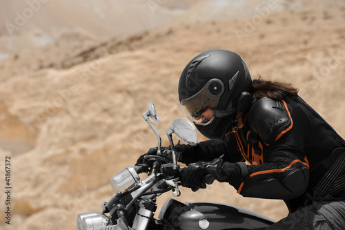 Fototapeta Naklejka Na Ścianę i Meble -  A motorcyclist in a desert