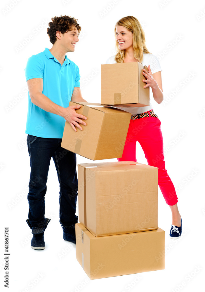 Couple carrying cardboard boxes Couple carrying cardboard boxes