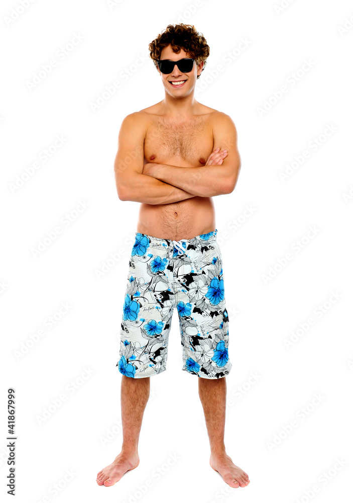 Beach guy posing shirtless, arms-crossed