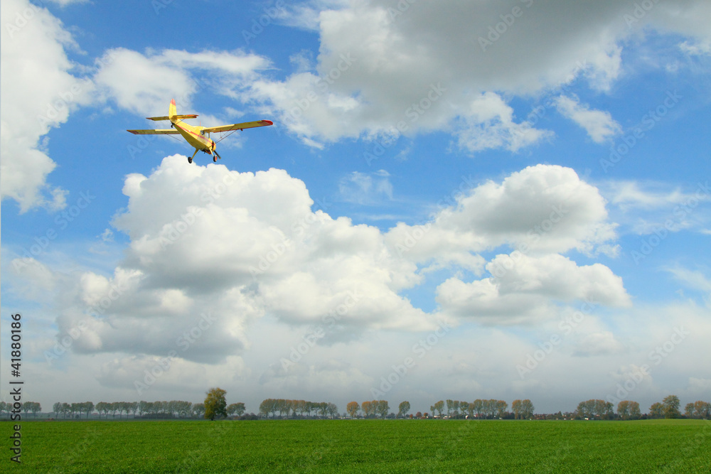 Yellow Aircraft against Overcast Sky - obrazy, fototapety, plakaty 