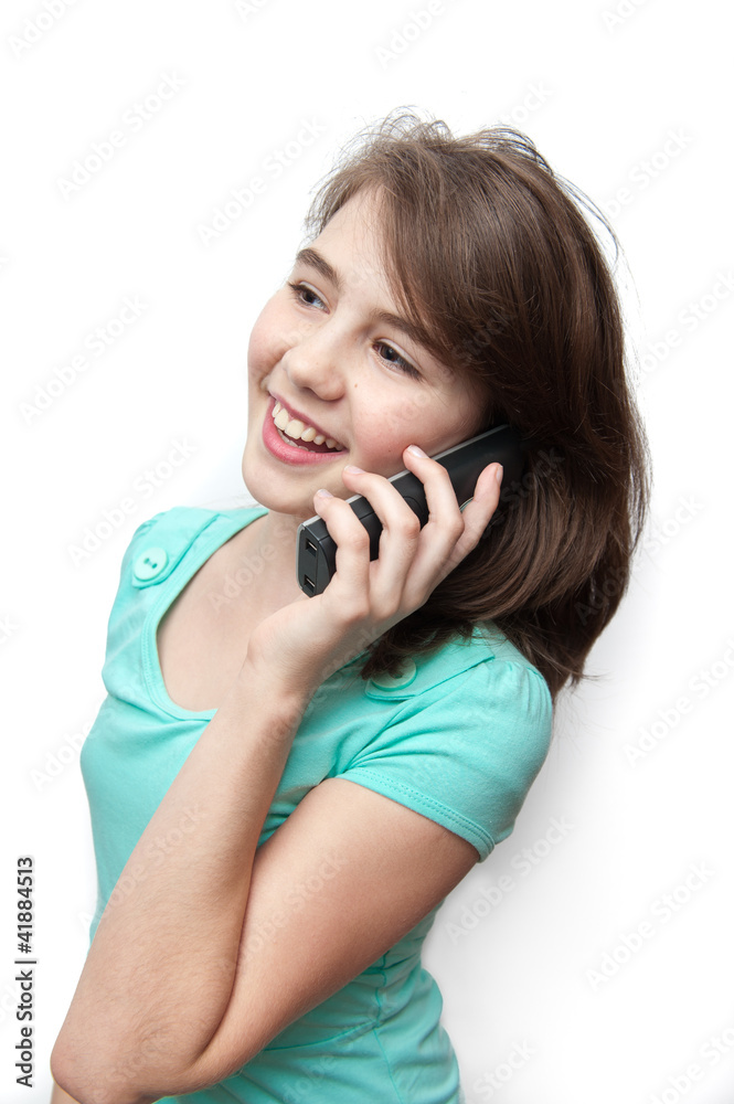 Attractive teenage girl talking on the phone. Isolated on white Attractive teenage girl talking on the phone. Isolated on white