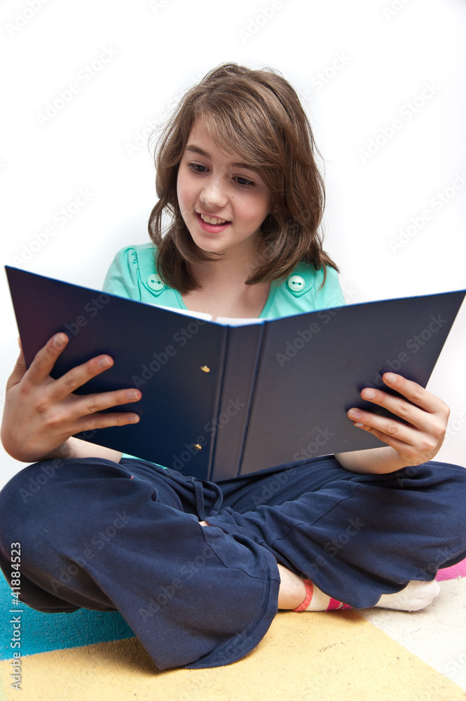 teen girl reading book and smiling teen girl reading book and smiling