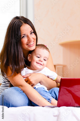mother and son are using laptop
