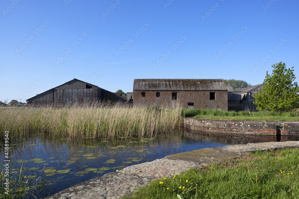 derelict canal with barns