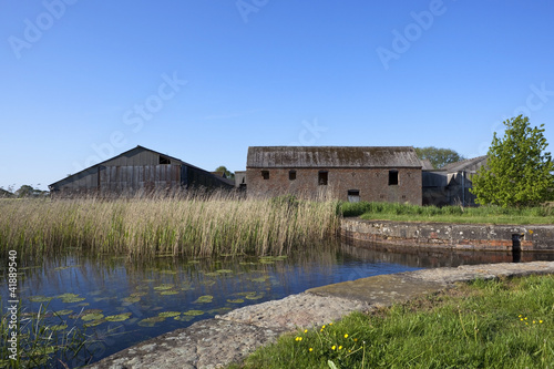 derelict canal with barns