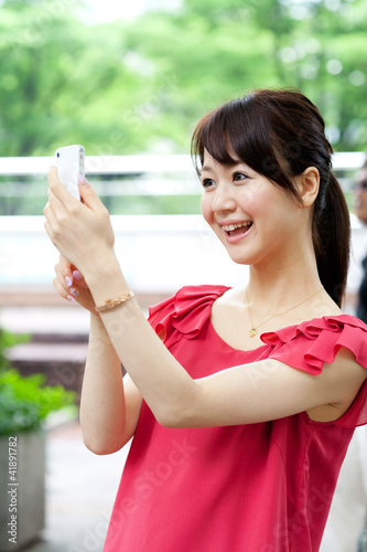 Beautiful young woman using a mobile phone