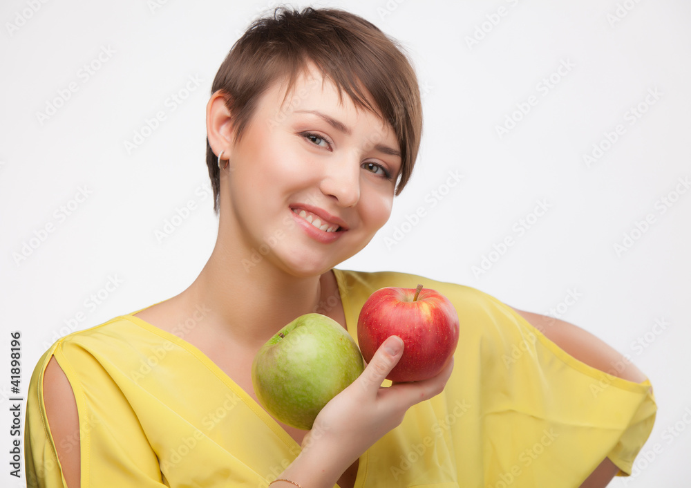girl holding a red and green apple. girl holding a red and green apple.