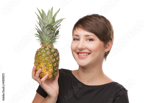 Beautiful smiling girl with pineapple