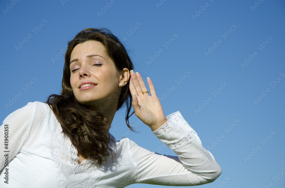 Young girl with closed eyes is listening intensively