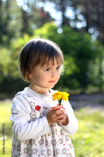 Girl smelling flower photo