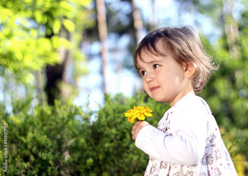 Lovely girl with yellow flower photo