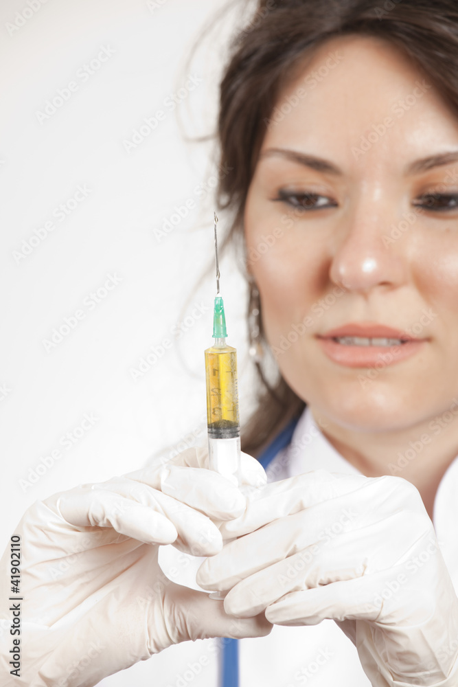 Close up of a beautiful woman doctor hold an injection Close up of a beautiful woman doctor hold an injection