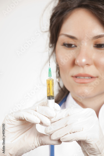 Close up of a beautiful woman doctor hold an injection