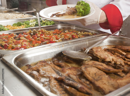chef standing behind full lunch service station