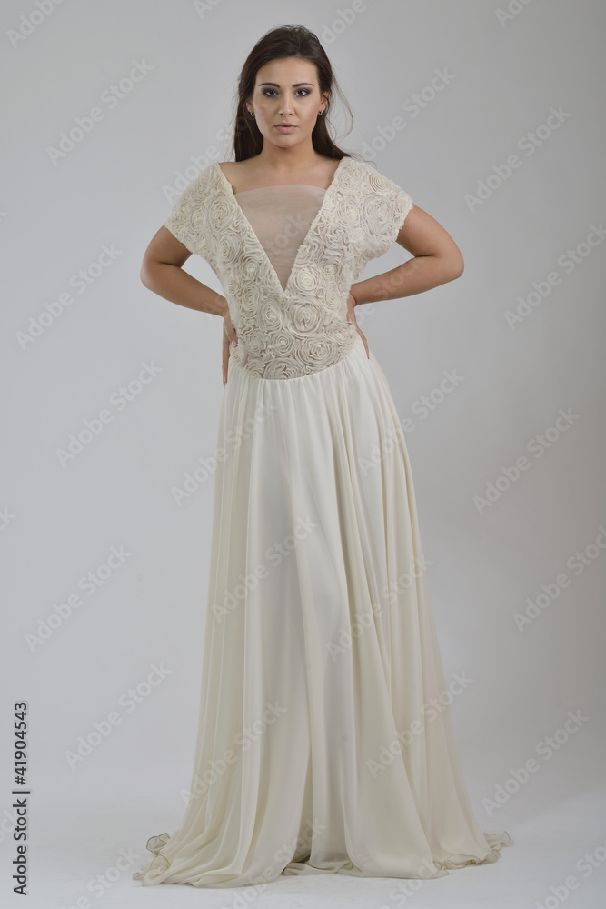 elegant woman in fashionable dress posing in the studio elegant woman in fashionable dress posing in the studio