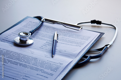 clipboard with stethoscope and pen photo