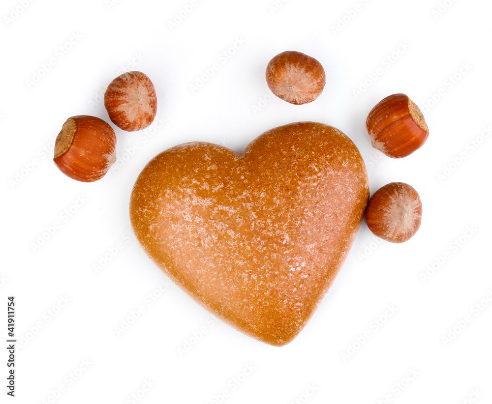 Heart-shaped cookie with hazelnuts isolated on white
