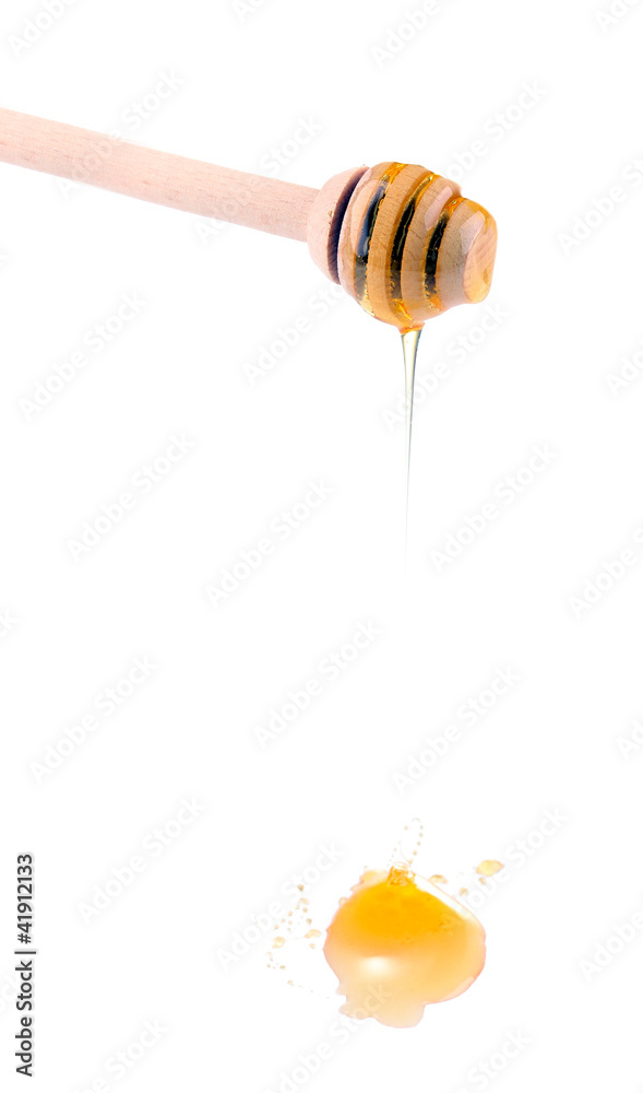 Sweet honey on drizzler isolated on white Sweet honey on drizzler isolated on white
