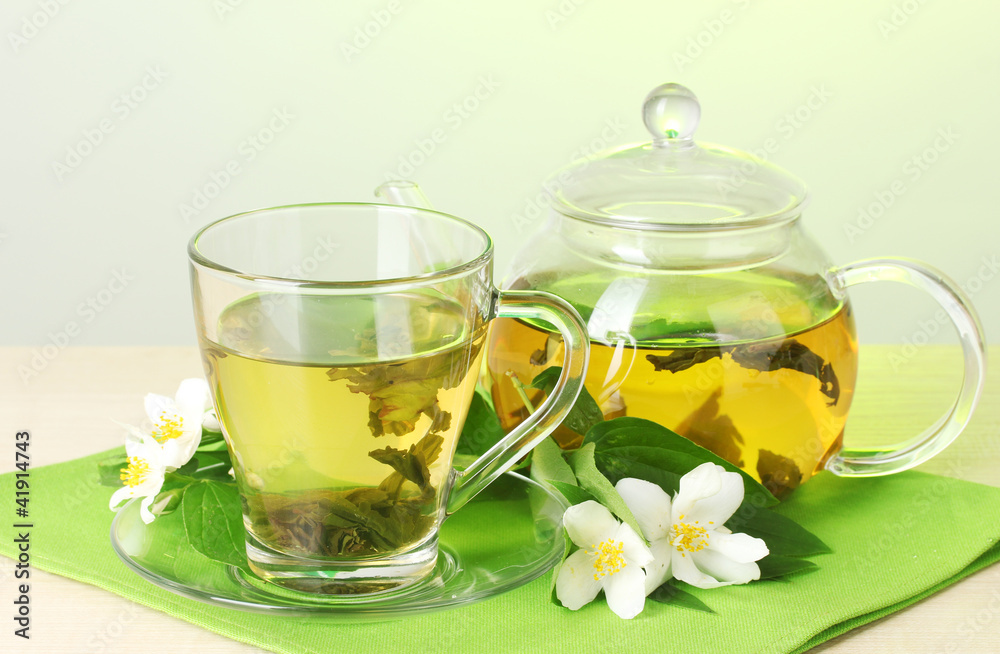 green tea with jasmine in cup and teapot green tea with jasmine in cup and teapot