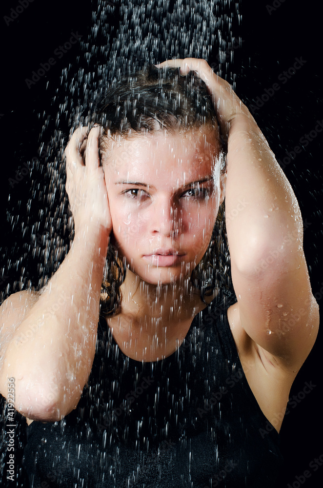 The girl under a shower on the black