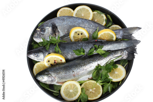 Fresh fishes with lemon, parsley and pepper