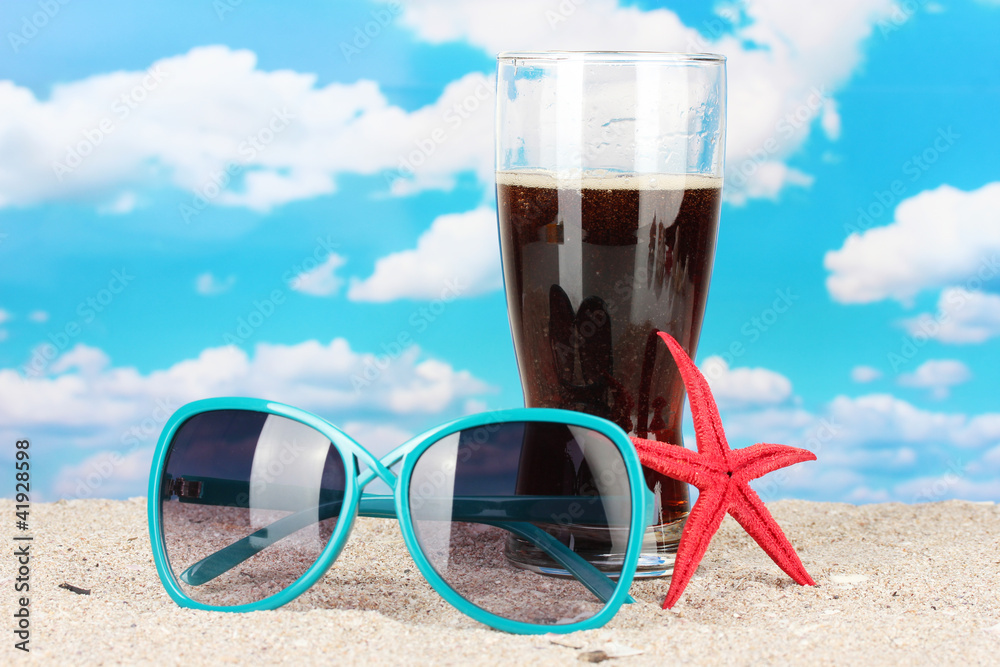 Beach composition of fashionable women's sunglasses and a