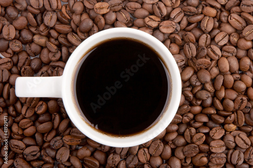 White coffee cup on coffee beans