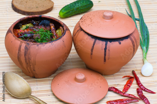 Meat baked with vegetables in rustic clay pot