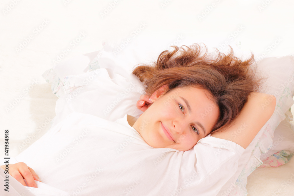 Attractive young woman relaxing in bed Attractive young woman relaxing in bed