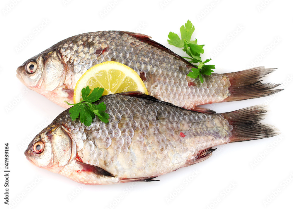 Fresh fishes with lemon and parsley isolated on white Fresh fishes with lemon and parsley isolated on white