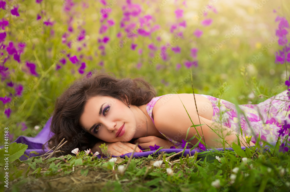 Beautiful young woman in purple flowers outdoors Beautiful young woman in purple flowers outdoors