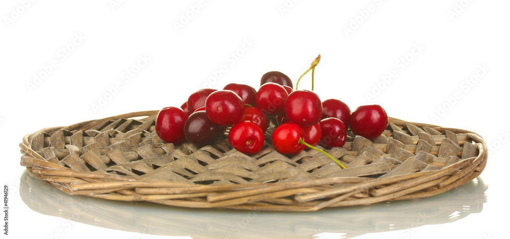 Cherry on the wicker cradle on white background close-up Cherry on the wicker cradle on white background close-up