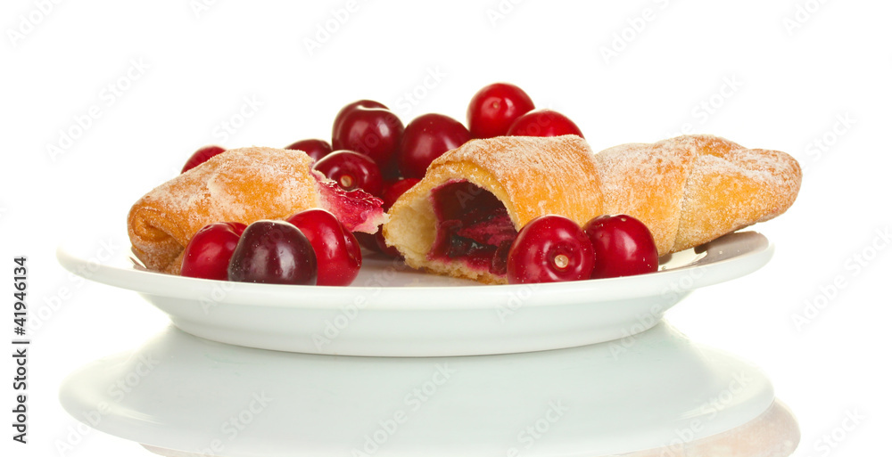 white plate with croissant and cherry isolated on white