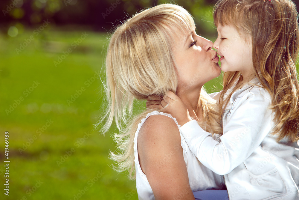 Mother holds her daughter in her arms Mother holds her daughter in her arms