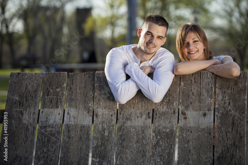 Young couple by the fence