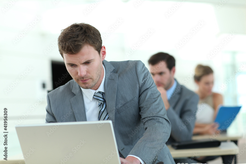 Salesman in grey suit attending business training Salesman in grey suit attending business training