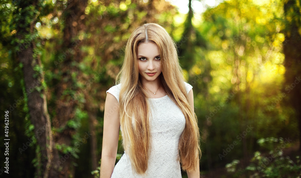The beautiful blonde in a short white dress The beautiful blonde in a short white dress