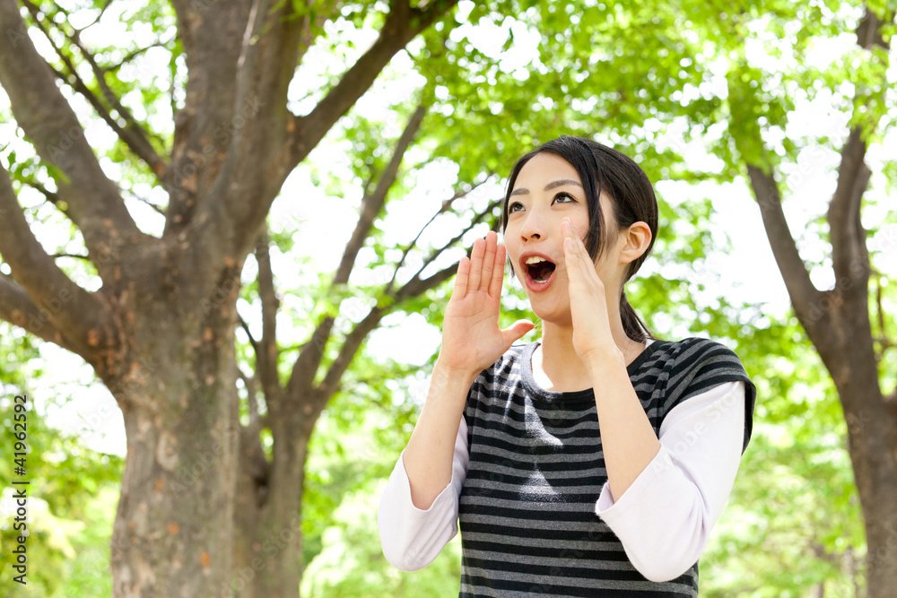 young asian woman cheering in the forest young asian woman cheering in the forest
